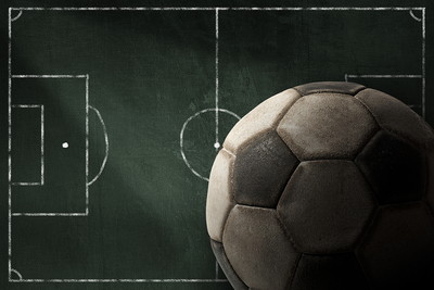 Football Against Chalkboard Pitch
