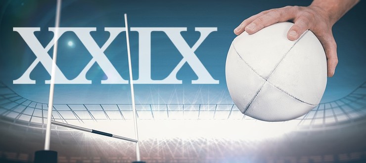 Rugby Player Holding Ball Against Floodlit Stadium with XXIX Text