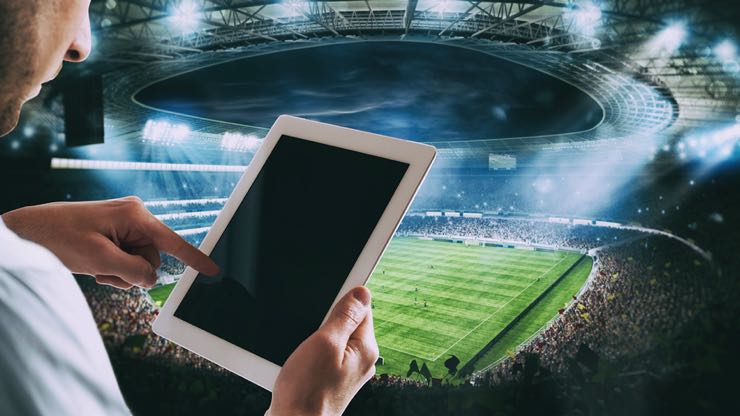 Man with tablet at stadium